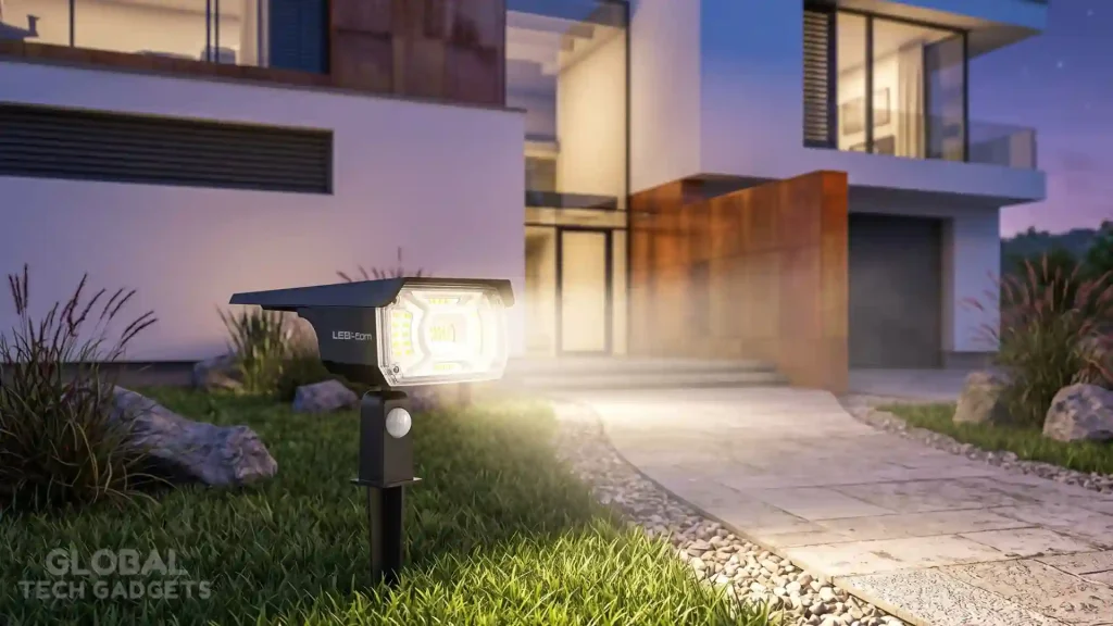 The 10 Best Outdoor Solar Lights 2 Lerekam solar spotlight on a lawn, casting a bright, warm light beam that clearly illuminates a textured stone garden path